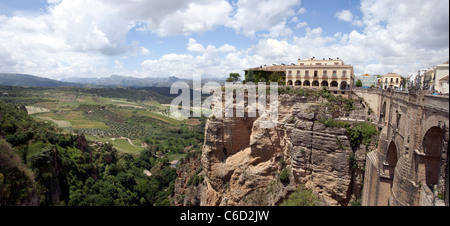 Historic Bridge over deep gorge to Ronda Spain. Hotels and apartments to scenic valley. from bridge. Stock Photo