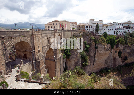 Historic Bridge over deep gorge to Ronda Spain. Hotels and apartments to scenic valley. Stock Photo