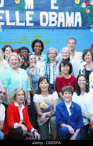 US First Lady Michelle Obama US First Lady Michelle Obama and Congressional spouses help to paint a mural and plant a butterfly Stock Photo
