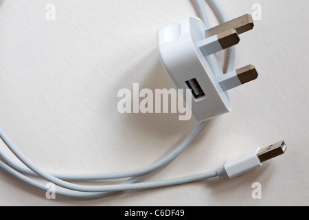 Three pinned plug with USB adaptor fitting for iphone 4 iphone4 on white background Stock Photo