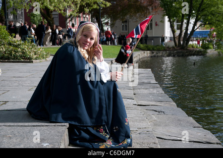 A Norwegian Woman weaving the national flag on the 17th of May, the Norwegian National Day. Stock Photo