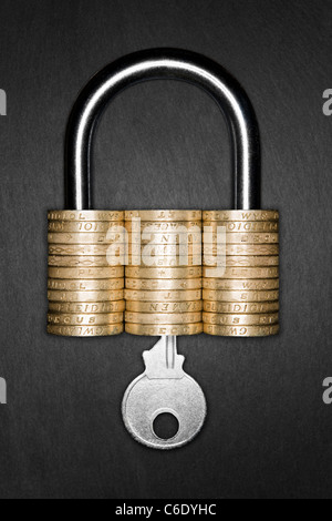 Financial Security concept. Padlock made form pound coins. Key inserted into padlock