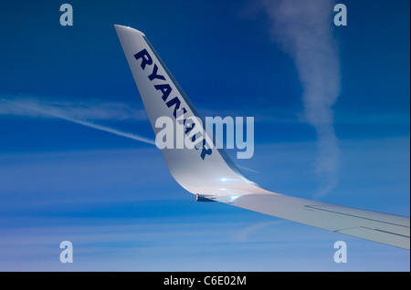 Ryanair wing tip shot from window of aircraft flying at 38,000 feet altitude over Italy Stock Photo