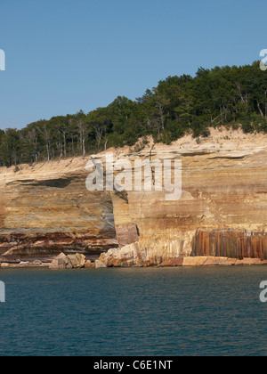 Michigan's Pictured Rocks has streaks on the face of the cliffs that comes from the groundwater leaching out of the rock. Stock Photo