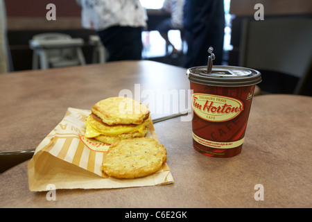 medium coffee and breakfast meal eating out in tim hortons coffee shop canada Stock Photo