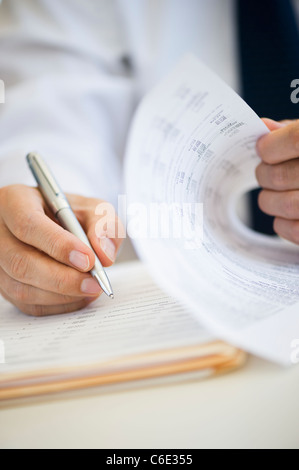 Businessman writing, close-up Stock Photo