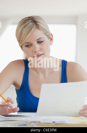 USA, New Jersey, Jersey City, Young blond woman doing paperwork Stock Photo