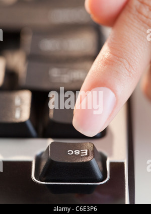 USA, New Jersey, Jersey City, Close up of woman's hand pressing escape key Stock Photo
