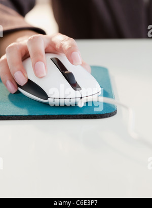 USA, New Jersey, Jersey City, Close up of woman's hand using computer mouse Stock Photo