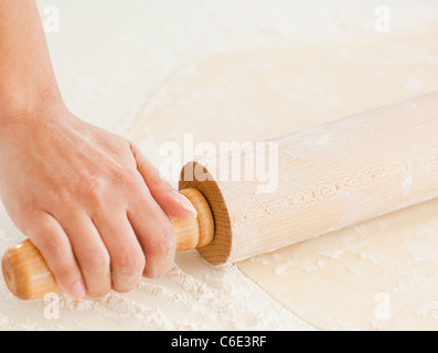 USA, New Jersey, Jersey City, Close up of woman's hand preparing dough with roller pin Stock Photo