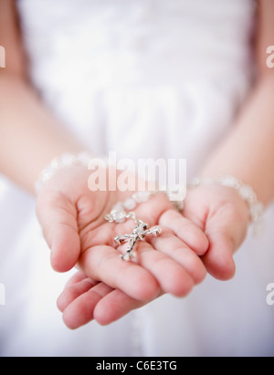 USA, New Jersey, Jersey City, Close up of girl's hands holding rosary beads Stock Photo