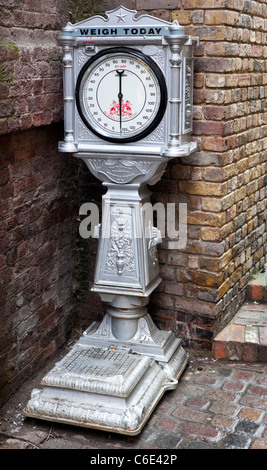 Antique coin operated weighing scale Stock Photo