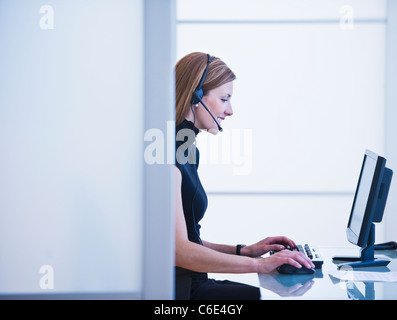 USA, New Jersey, Jersey City, Young woman working in office Stock Photo