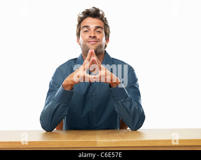 Smiling business man sitting at table and gesturing Stock Photo