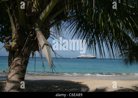 Tropical Beach with cruise ship on the horizon Caribbean Stock Photo