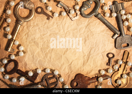 Blank sheet of crumpled paper, framed different old keys Stock Photo