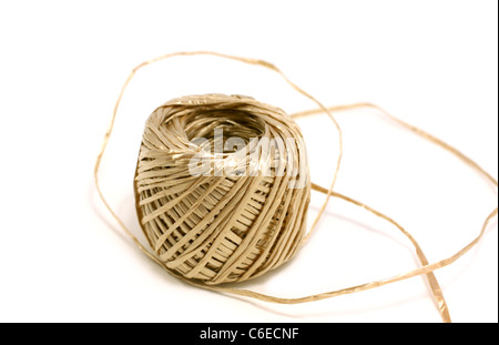 skein of golden thread on white Stock Photo