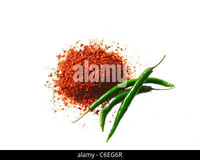 Studio shot of Red Chili Powder and Whole Green Chilies on white background Stock Photo