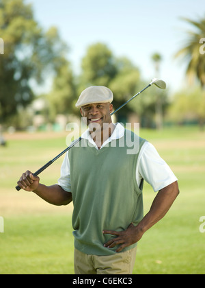 USA, Arizona, Scottsdale, Smiling man on golf course holding golf club Stock Photo