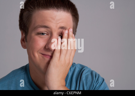 Portrait of sleepy teenager, studio shot Stock Photo