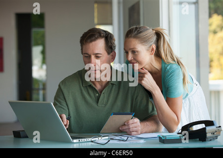 Mature couple working on laptop at home Stock Photo