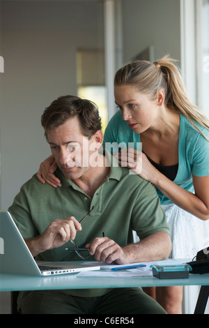Mature couple working on laptop at home Stock Photo