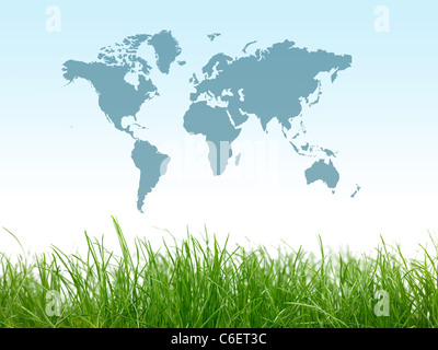 Green grass isolated against a blue sky with a world map Stock Photo