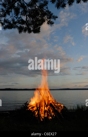 Mid-summer bonfire by lake Paijanne, Finland Stock Photo