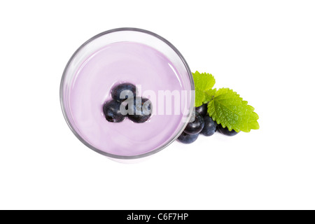 blueberries on top of a blueberry milkshake with blueberries and melissa aside on white background Stock Photo