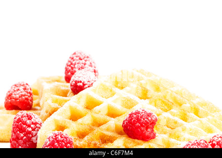 sugar covered raspberries on waffles with syrup on white background Stock Photo