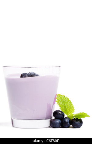 some blueberries with melissa near a milkshake with blueberries on white background Stock Photo