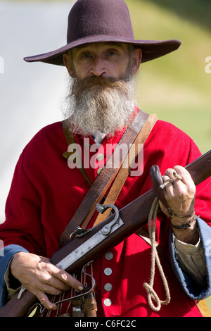 Senior bearded man holding gun for hunting, side view. Forest ...