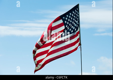 American flag on a flagpole blowing in the wind Stock Photo