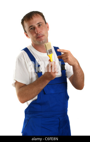Craftsman with a yellow paintbrush in his hand Stock Photo