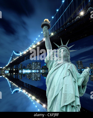 Manhattan Skyline, Brooklyn Bridge and The Statue of Liberty at Night Lights, New York City Stock Photo