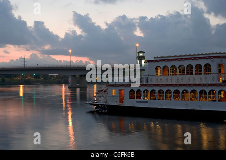 riverboat on mississippi river docked on Boom Island at dusk with plymouth avenue bridge in background in minneapolis minnesota Stock Photo