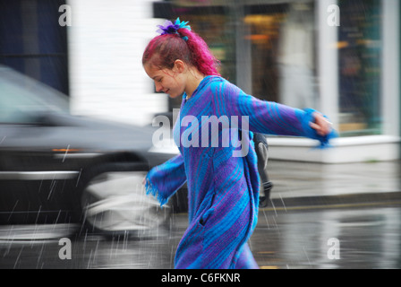 young woman in rainy Glastonbury, United Kingdom Stock Photo