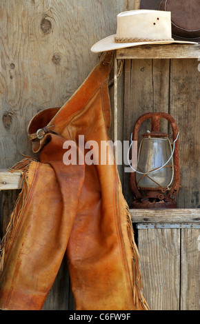 Vintage cowboy boots, hat and rope on an old handmade bench on an old ranch  in New Jersey, USA, farm Stock Photo - Alamy