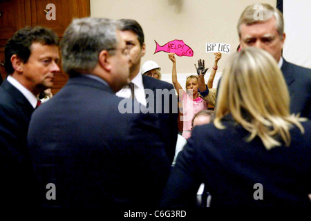 Protestors holding up signs after the testimony Tony Hayward, CEO of BP oil and energy company testifies at a House Energy and Stock Photo