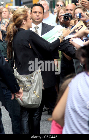 Miley Cyrus signing autographs Celebrities outside Ed Sullivan Theatre for the 'Late Show With David Letterman' New York City, Stock Photo