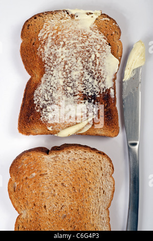 Wholemeal brown bread buttered toast Stock Photo