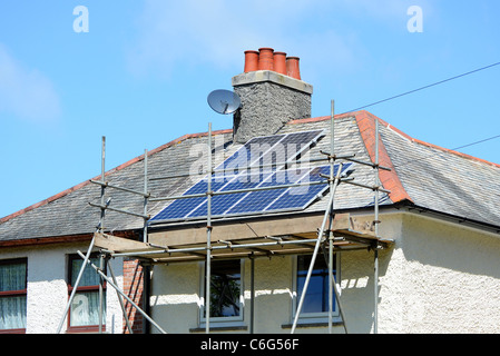 Solar Roof Panels being fitted to suburban house in Manchester, UK Stock Photo