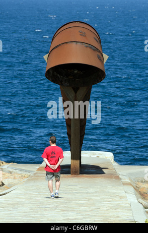 A man walking towards the snail shell sculpture near Hercules Tower - Coruna, Spain Stock Photo