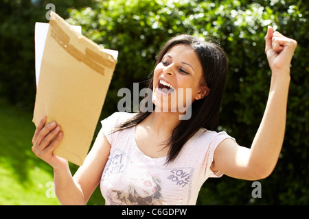 Ethnic girl sat with exam results Stock Photo