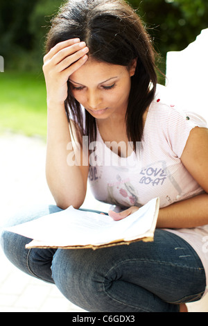 Asian girl looking at exam results Stock Photo