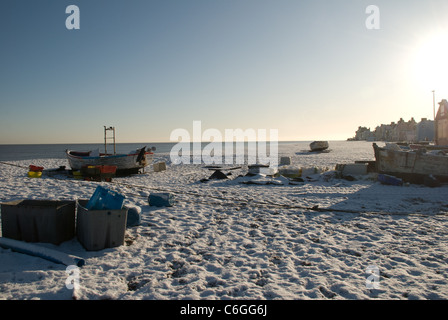 Old Fishing Boats Wintering on Aldeburgh Beach in the Snow. Stock Photo