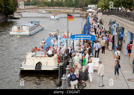 River Spree in Berlin near Berliner Dom. Tourists waiting for their sightseen tour on the flat boat around the town. Germany Stock Photo