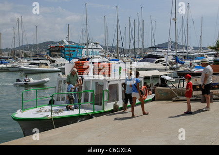 Passengers disembark from a small Aqua Bus ferry in the harbour at Eivissa Ibiza a Spanish Mediterranean island Stock Photo