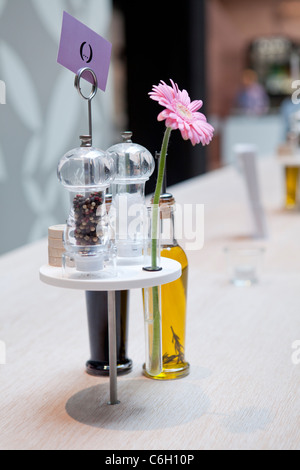 SALT AND PEPPER WITH GERBERA ON THE TABLE AT HOLYFIELDS, UNTEN DEN LINDEN, BERLIN, GERMANY Stock Photo