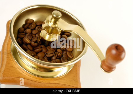 Stock photo of a Coffee grinder with coffee beans close-up Isolated over white background Stock Photo